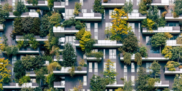 Green plants and trees growing on Bosco Verticale residential apartment building balconies, Milan, Italy