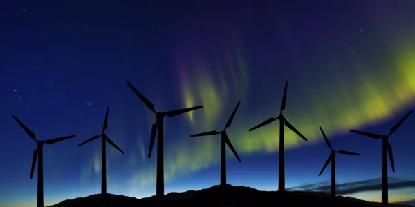 Wind turbines in the mountains on the background of the northern lights in Norway